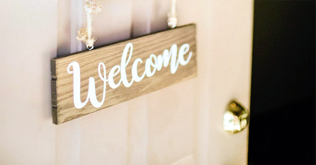 opening door with welcome sign